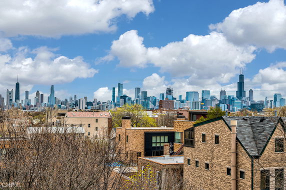 Panoramic view of a city skyline with various tall buildings.