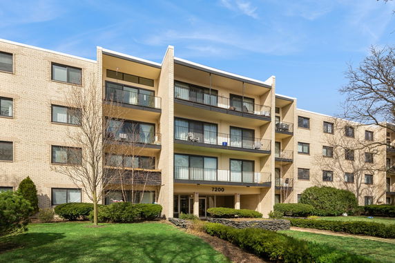 Front view of a four-story apartment building with balconies.
