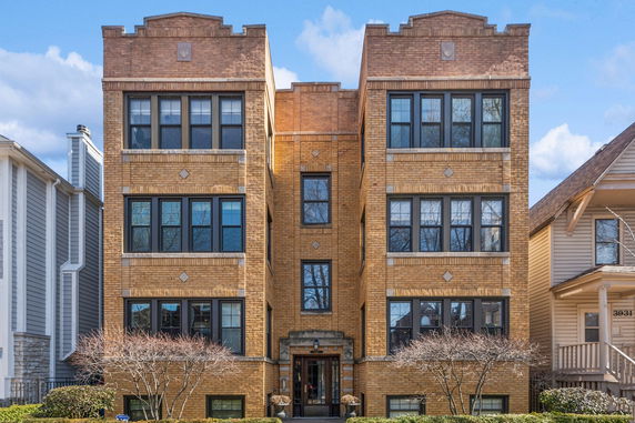 Front view of a multi-story brick apartment building.