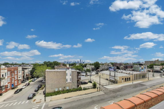 Panoramic view of urban area with buildings and distant city skyline.