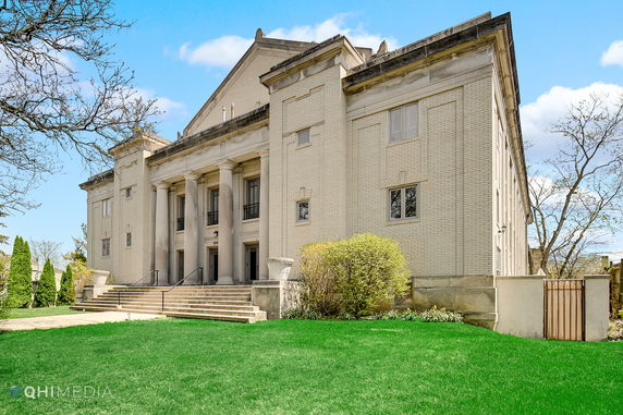 Front view of a large building with columns and steps.