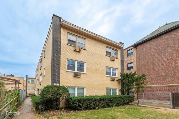 Front view of a three-story brick apartment building