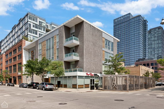 Front view of a modern multi-story building with balconies.