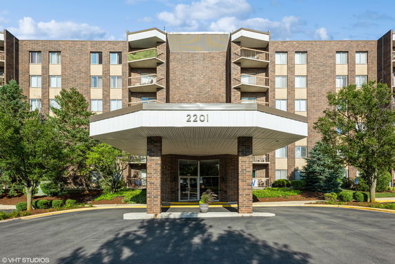 Front view of a multi-story brick building with balconies.