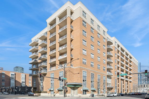 Front view of a multi-story building with balconies.