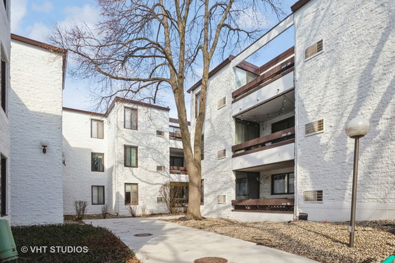 View of a multi-story residential building with balconies.