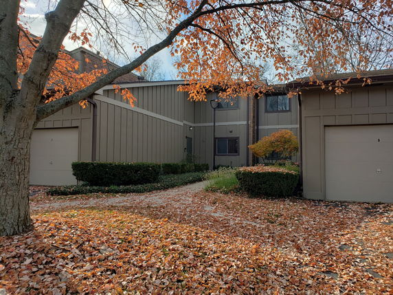 Front view of a two-story house with garages on either side.