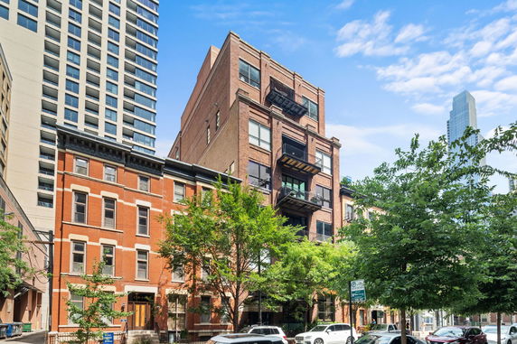 Front view of multi-story brick buildings in an urban setting.
