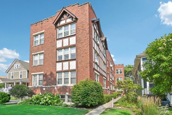 Front view of a multi-story brick apartment building.