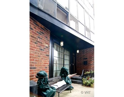 Front view of a modern building with a brick facade and large windows.
