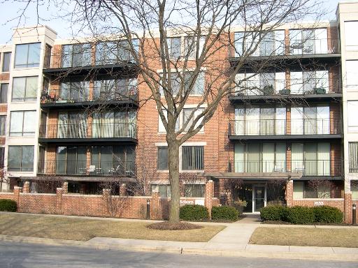 Front view of a multi-story apartment building with balconies.