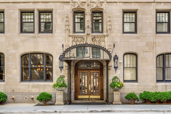 Front view of a multi-story building with ornate entrance and decorative elements.