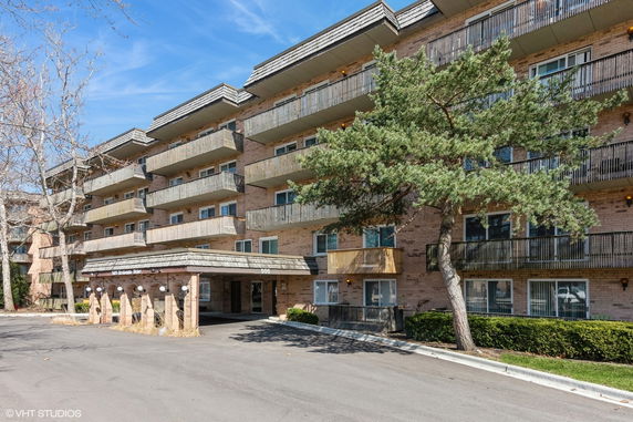 Front view of a multi-story apartment building with balconies