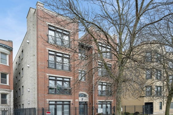 Front view of a multi-story brick apartment building.
