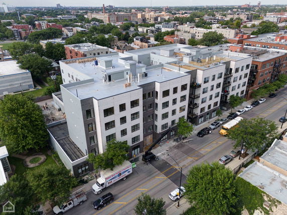 Aerial view of a large, multi-story residential building with a modern design.