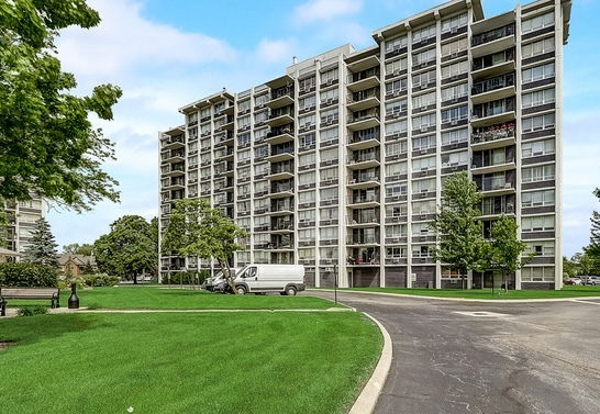 Front view of a multi-story apartment building with balconies.