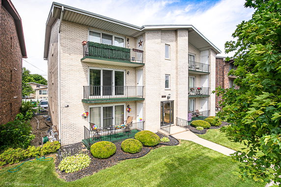 Front view of a multi-story apartment building with balconies.
