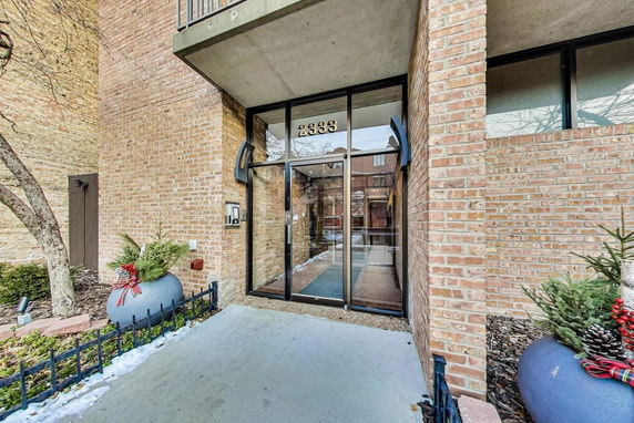 Entrance of a brick building with glass doors.