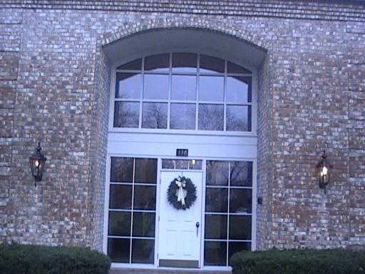Front view of a building with large windows and a central entrance.