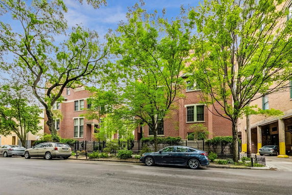 Front view of a brick multi-story residential building.