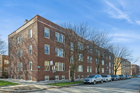 Front view of a multi-story brick apartment building.