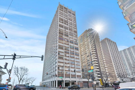 Front view of a tall apartment building in an urban setting.