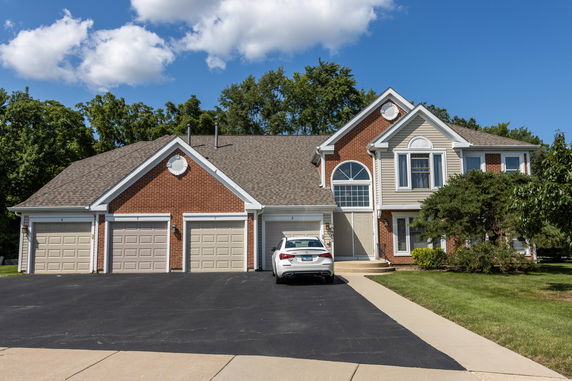 Front view of a two-story house with a three-car garage.