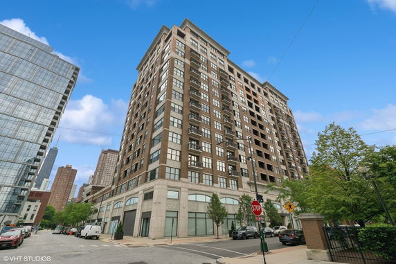 Front view of a multi-story building with large windows and balconies.