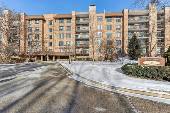 Front view of a multi-story residential building with balconies.
