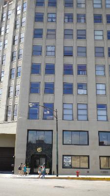 Front view of a multi-story commercial building with numerous windows.