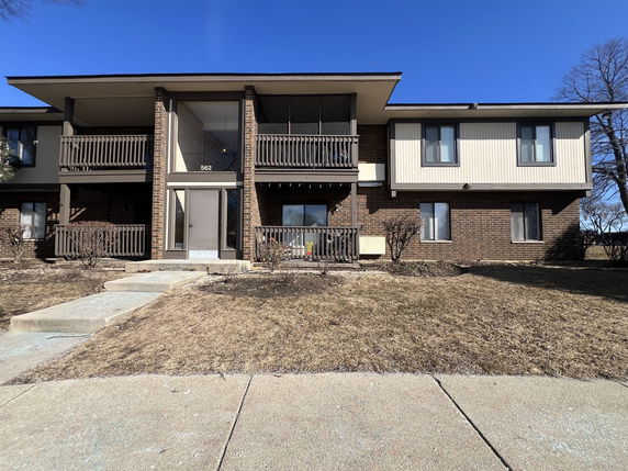 Front view of a two-story residential building with balconies.
