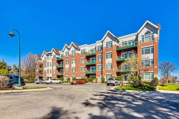 Front view of a multi-story apartment building with balconies.