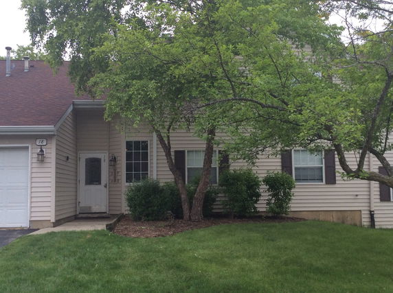 Front view of a single-story house with a garage and a main entrance.