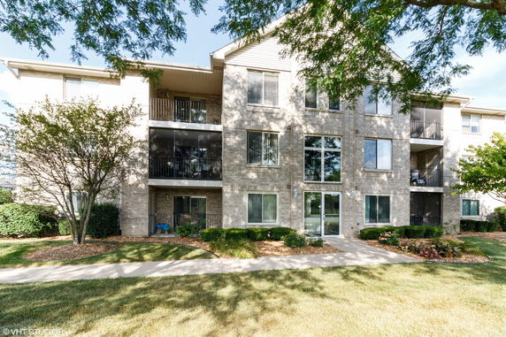Front view of a multi-story apartment building with balconies.
