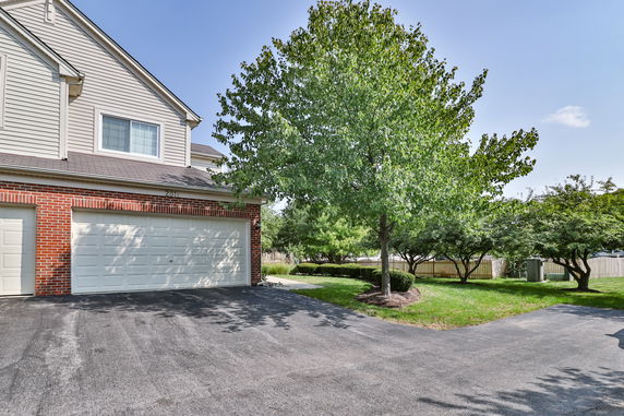 Front view of a house with a double garage and brick exterior.