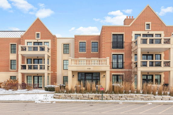 Front view of a multi-story brick building with balconies.