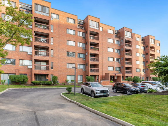 Front view of a multi-story brick apartment building.