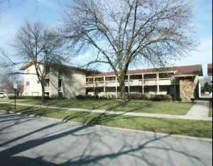 Front view of a two-story building with a sloped roof.