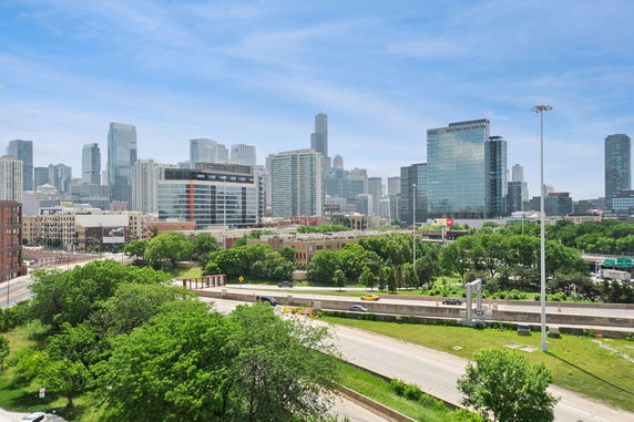 Wide-angle view of a city skyline with skyscrapers and roads.