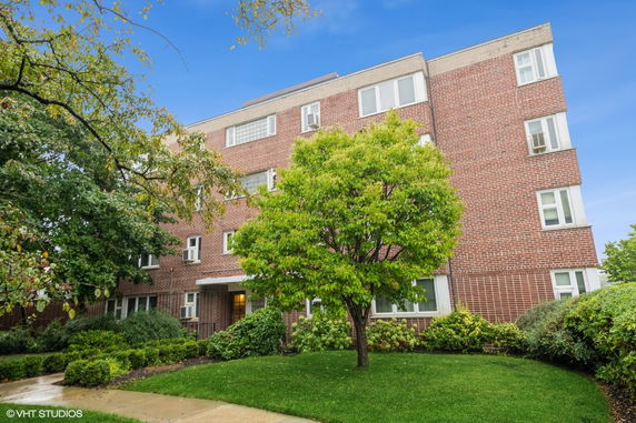 Front view of a multi-story brick apartment building.