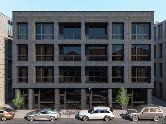 Front view of a modern multi-story apartment building with large windows and a symmetrical facade.