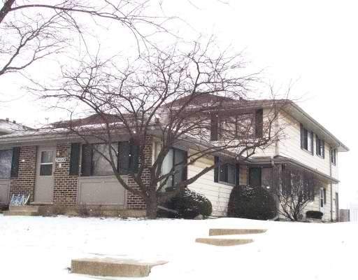 Front view of a two-story house with brick and siding exterior.