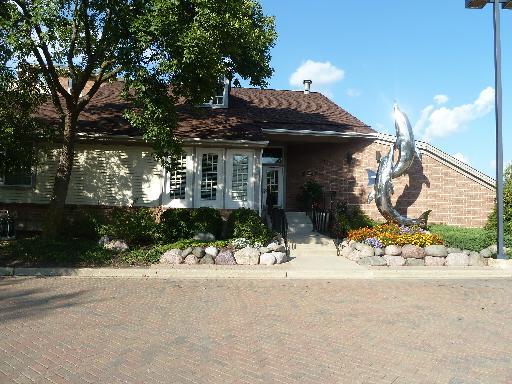 Front view of a house with a sculpture near the entrance.