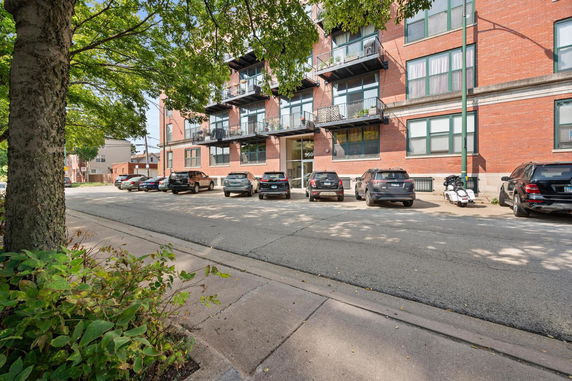 Front view of a multi-story apartment building with balconies.