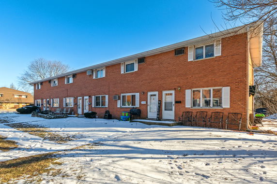 Front view of a two-story brick apartment building.