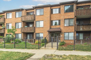 Front view of a three-story apartment building with balconies.