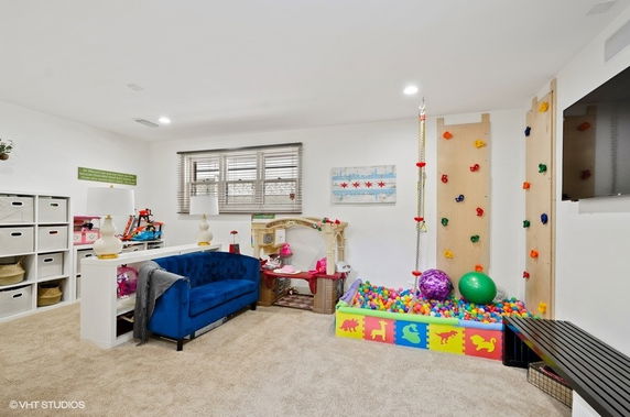 Indoor play area with climbing wall and ball pit