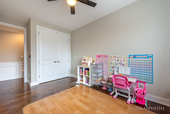 Room with children's furniture and educational charts on the wall