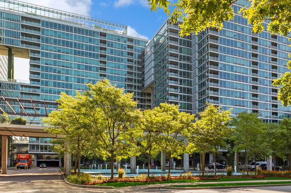 Front view of a modern glass high-rise building with extensive windows.