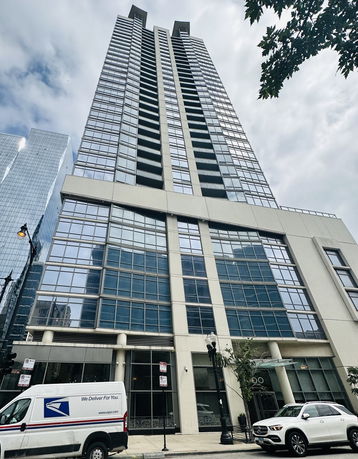Front view of a tall modern building with numerous windows.
